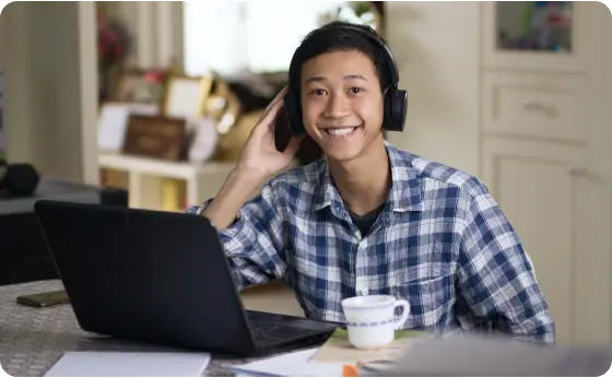 Student wearing a black pair of headphones