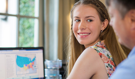 happy girl studying in her computer