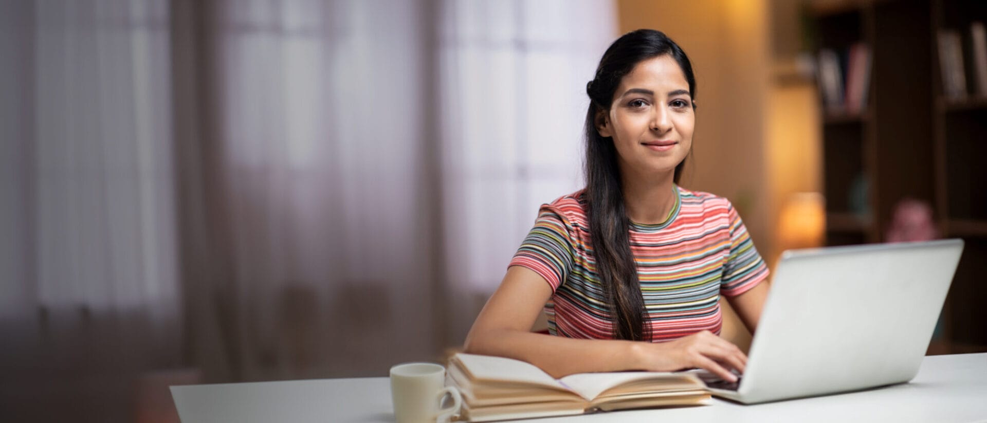 Girl smiling and using her computer