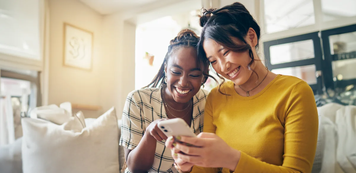 Two students looking at their phone together